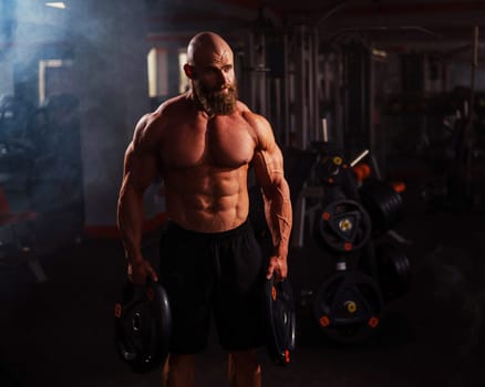 Caucasian bald man posing in the gym