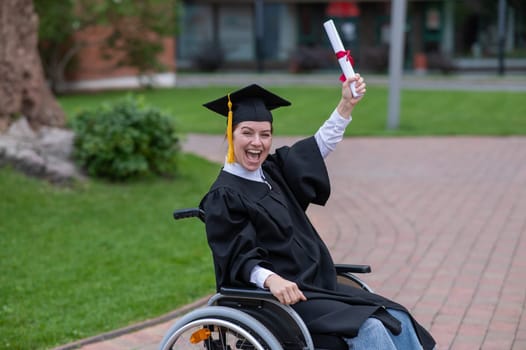 Happy caucasian woman in a wheelchair holding her diploma outdoors