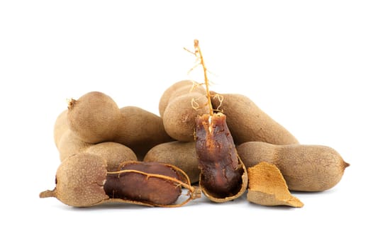 Tamarind fruits, whole and cracked open isolated on white background (Tamarindus indica)