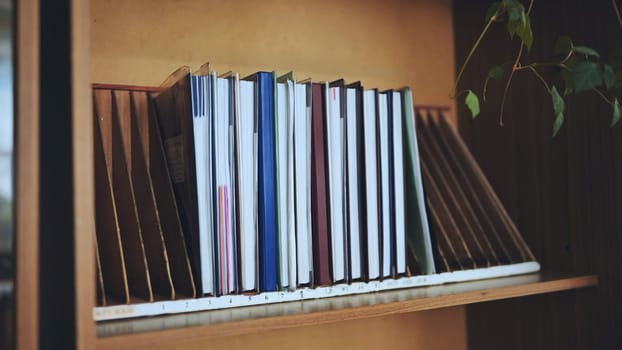 The teacher takes a school teacher's magazine from the shelf