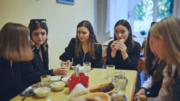 Senior girls having breakfast in the school canteen