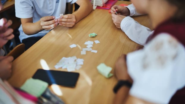 Children play with homemade small papers