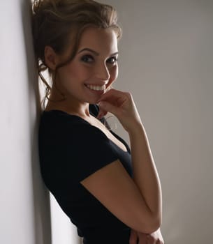 Attractive brunette in black dress smiling at camera