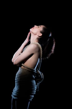 Bondage or BDSM, Shibari. Image of nude woman tied with rope