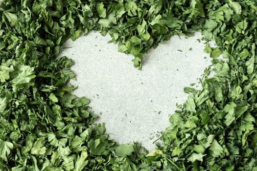 Fresh dried greenery parsley in shape of heart adaptogens ingredient. Herbal medicine healthy eating. Superfood prebiotic food. Sustainable homegrown organic herbs