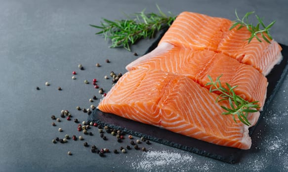 Raw salmon fillet and ingredients for cooking, seasonings and herbs, with copy space for text.