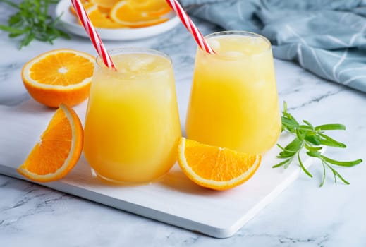 Glass of orange juice with ice. Cold orange fresh. Glass of orange juice for hot summer day.