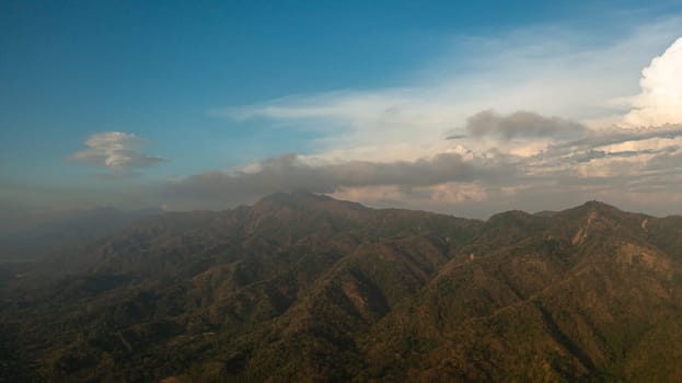 Top view of Sunset in the mountains against the blue sky and clouds. Philippines.