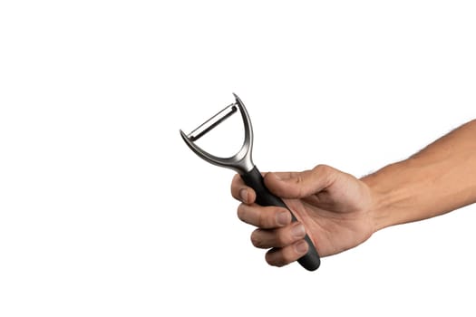 Black male hand holding a potato peeler isolated on white background. High quality photo