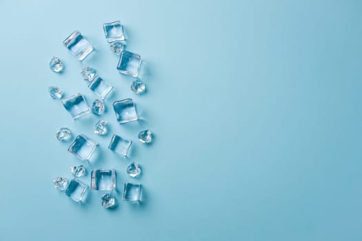 top view of ice cubes of different sizes on blue background