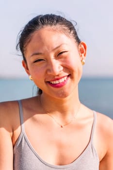 close up portrait of a cute asian woman smiling happy looking at camera, concept of beauty and purity