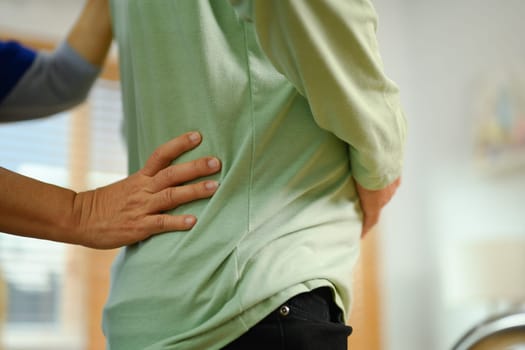 Closeup shot of examining senior man's back. Rehabilitation and Healthcare concept.