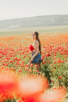 Woman poppies field. portrait of a happy woman with long hair in a poppy field and enjoying the beauty of nature in a warm summer day