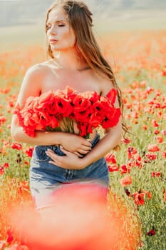 Woman poppies field. portrait of a happy woman with long hair in a poppy field and enjoying the beauty of nature in a warm summer day