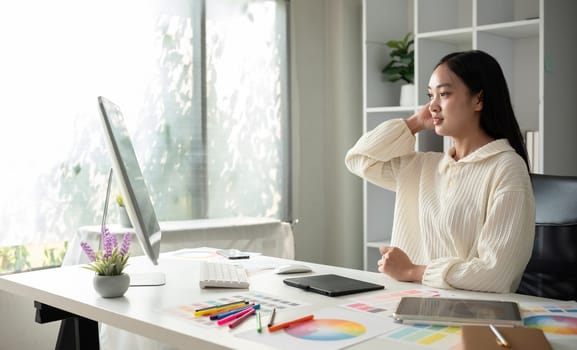 Female designer working in graphic design Choose colors for working on tablets and computer designs..