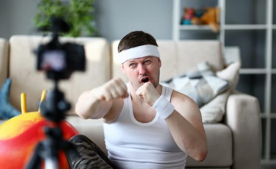 Bearded Man Recording Boxing on Digital Camera. Sportsman Shooting Video on Professional Camcorder for Sport Blog. Funny Blogger Doing Fitness Exercise to Warmup Hands Close-up Photography