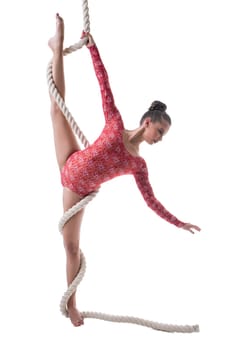 Graceful female gymnast doing vertical splits with rope