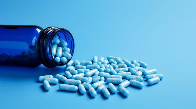 Blue pills, capsules and vitamins in a jar on a blue background. Medicine, treatment in a medical institution, healthy lifestyle, medical life insurance, pharmacies, pharmacy, treatment in a clinic.