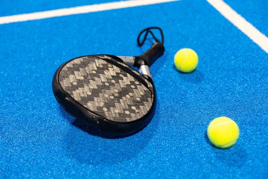 paddle tennis racket and balls on court, night image. High quality photo