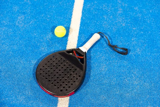 professional paddle tennis racket with natural lighting on blue background. Horizontal sport theme poster, greeting cards, headers, website and app. High quality photo