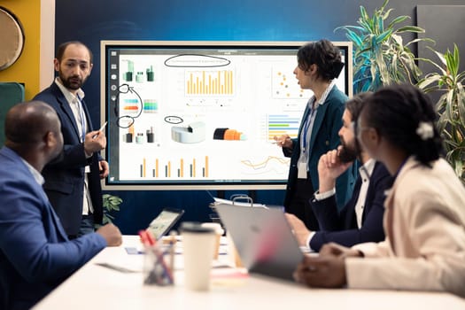 Team leaders attending meeting in a boardroom and talking sense into his employees, trying to identify challenges or obstacles hindering progress. Manager and staff struggling with a project.