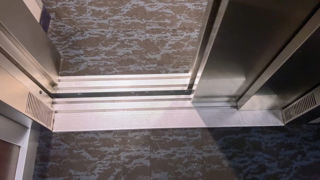 The detailed view of an elevator threshold where the cabin meets the building floor, highlighting the transition space that facilitates safe entry and exit.