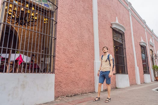 Man tourist explores the vibrant streets of Valladolid, Mexico, immersing herself in the rich culture and colorful architecture of this charming colonial town.