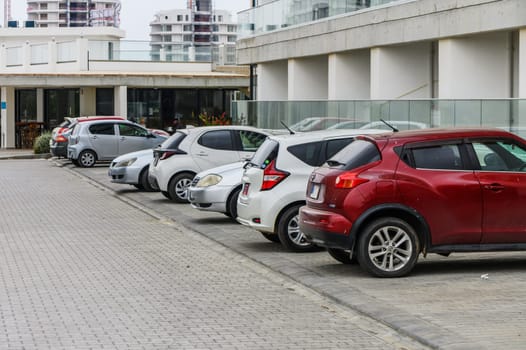 Cars are parked in the paved parking lot and in the parking lot near the house 2