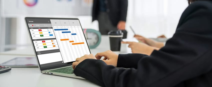 Project planning software for modish business project management on the computer screen showing timeline chart of the team project