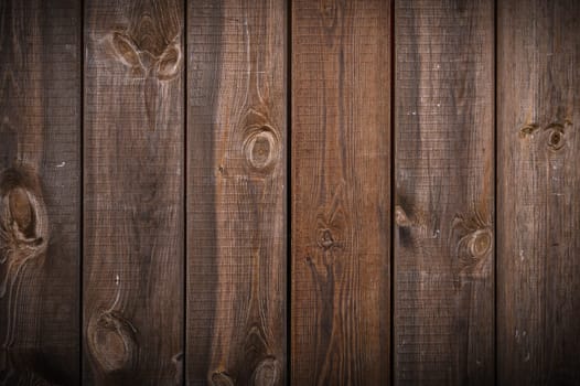 Background of old brown boards with visible grain and damage.