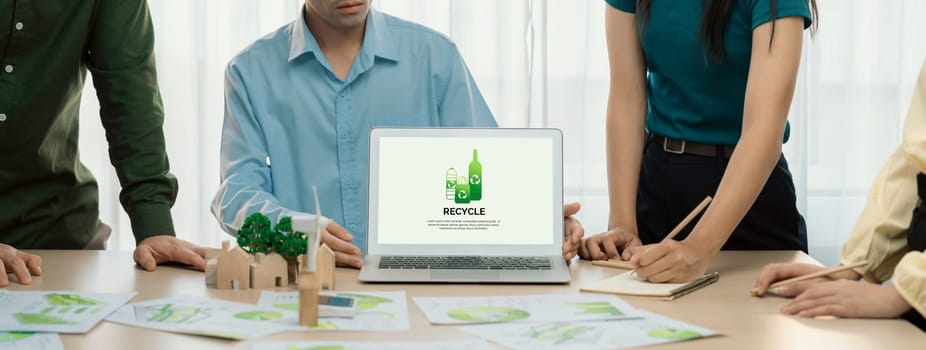 Recycle packaging displayed on laptop at a green business meeting while business team presenting green design. ESG environment social governance and Eco conservative concept. Closeup. Delineation.