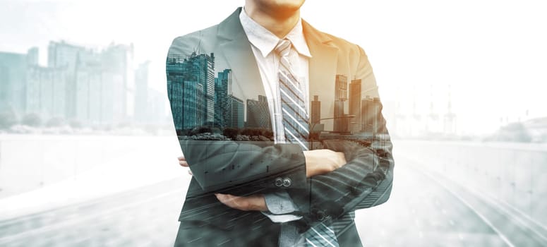 Double Exposure Image of Business Person on modern city background. Future business and communication technology concept. Surreal futuristic cityscape and abstract multiple exposure interface. uds