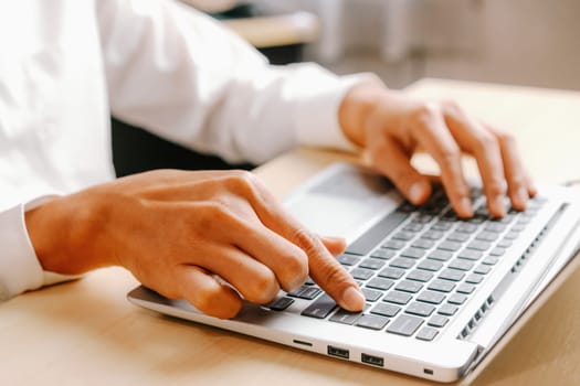 Businessman hand typing on computer keyboard of a laptop computer in office. Business and finance concept. uds