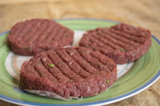 raw beef hamburger ready to be cooked in a dish