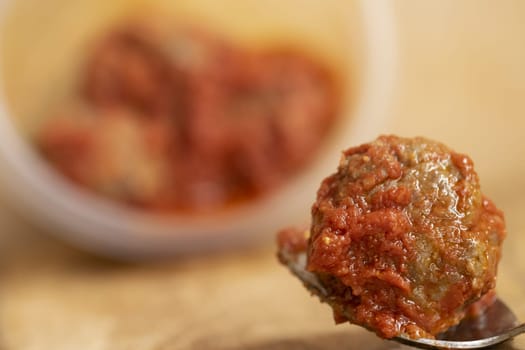 meatball in tomatosauce in a plastic bowl