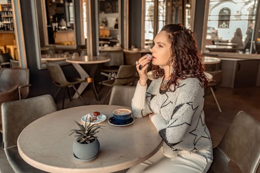 Woman cafe coffee breakfast. Portrait of an adult beautiful woman in an elegant suit in a cafe.