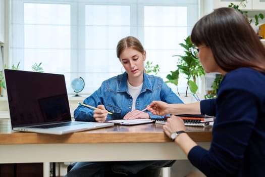 Young teenage girl high school student patient talking with psychologist, therapist, counsellor, social worker. Mental session therapy, support, psychology, psychotherapy, adolescence, youth concept