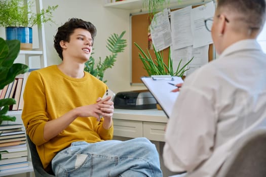 College student guy at meeting with professional counselor, social worker. Youth, mental problems, psychology, psychotherapy, counselling