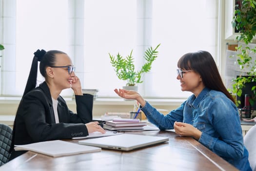 Mental therapy session of positive smiling middle-aged female patient with psychological counselor social worker psychotherapist. Psychology psychotherapy counseling, social service support treatment