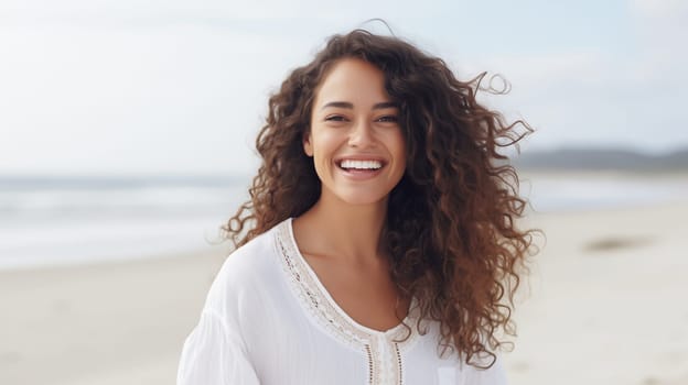 Summer portrait of beautiful relaxed happy smiling young woman standing on sunny beach with white sand enjoying vacation at sea coast