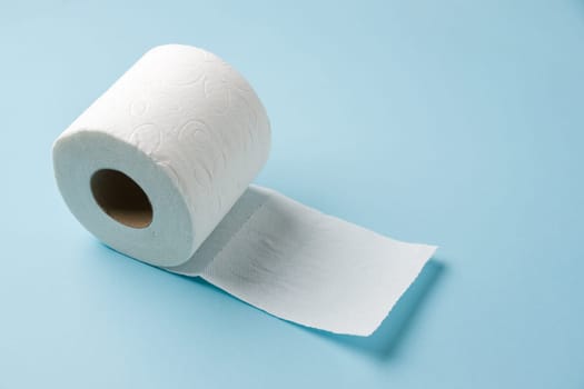 Top view of toilet paper roll on blue background