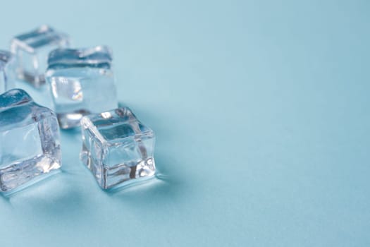 top view of ice cubes of different sizes on blue background