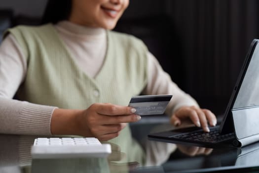 Young woman using credit card and tablet for buying online shopping at home , payment, buying and online shopping concept.