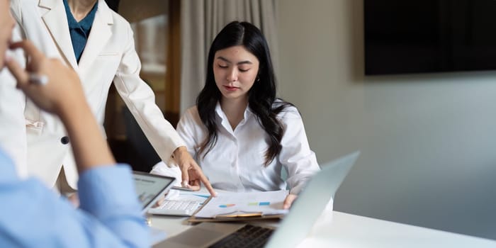 Happy business woman talking and discuss in office boardroom. Business professional sitting in meeting with colleagues.