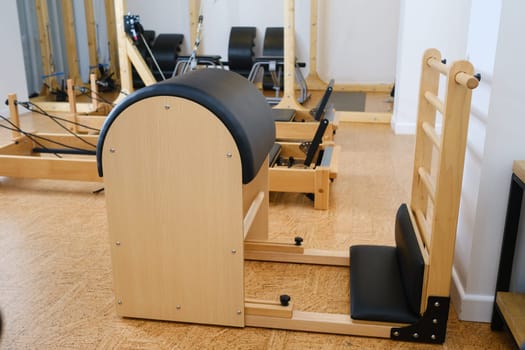 Pilates simulator is a barrel in the yoga room. Pilates equipment.