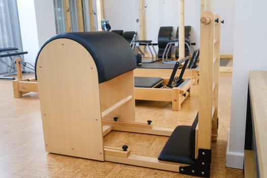 Pilates simulator is a barrel in the yoga room. Pilates equipment.