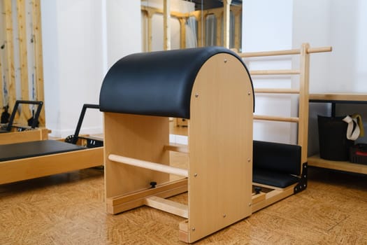 Pilates simulator is a barrel in the yoga room. Pilates equipment.