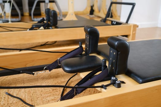 the reformer machine in the pilates room. Yoga equipment.