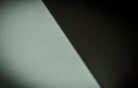 , diagonally divided gray wall casting a shadow as a background 2