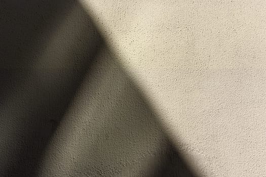 , diagonally divided gray wall casting a shadow as a background 5